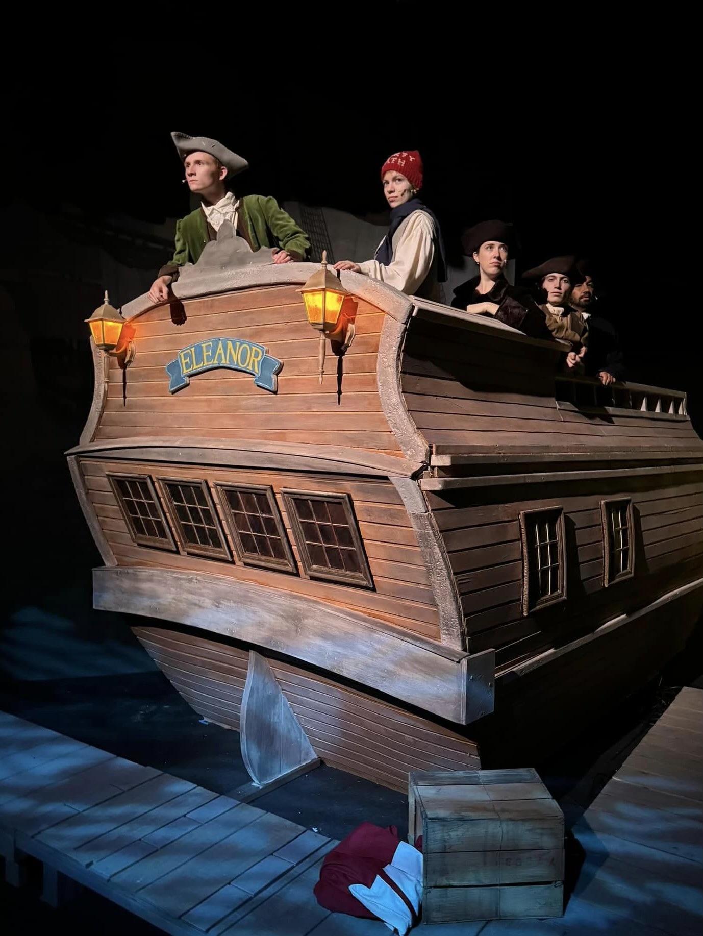Cast in colonial costume aboard the ship Eleanor on stage