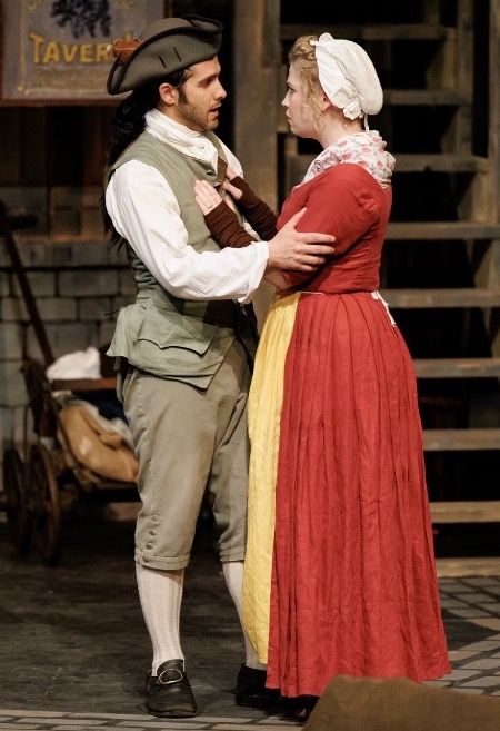 Two actors in colonial dress in a tavern scene